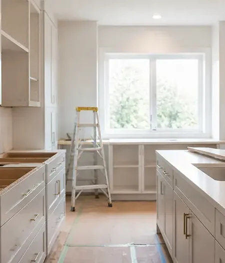 Kitchen renovation in progress in the GTA with cabinets being installed and a step ladder